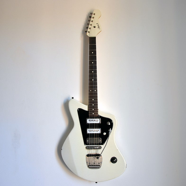 White Aura electric guitar on the wall