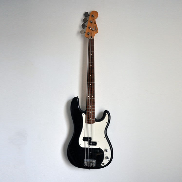 Black Precision Bass on the wall with levitation Hanger